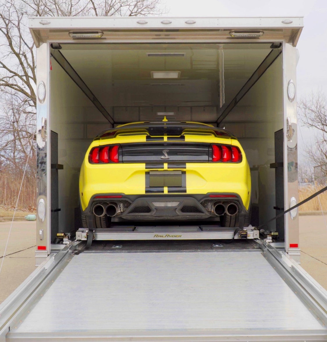 Yellow Mustang loaded into our enclosed trailer for concierge pickup